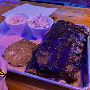 a plate of ribs and coleslaw