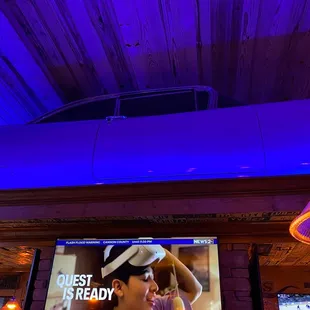 a car on the ceiling of a bar