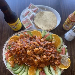 Mariscada. Deep fried tilapia fish topped with spicy sauce mixed with shrimp and octopus.
