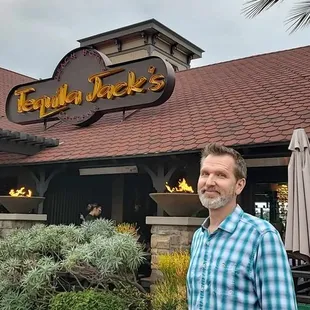 a man standing in front of a restaurant