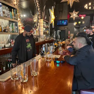two men sitting at a bar