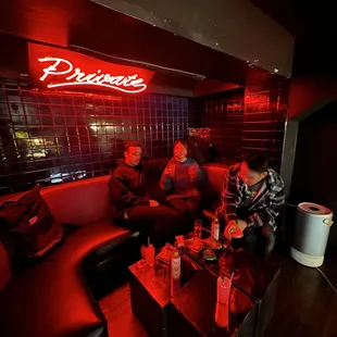 a group of people sitting on a couch in a dimly lit room