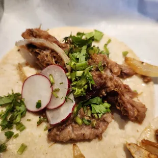 a taco with meat and vegetables