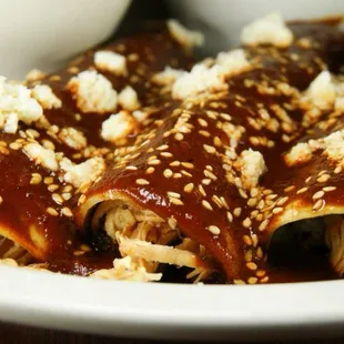 Chicken Enchiladas with our family recipe mole sauce.