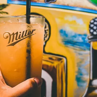 a hand holding a drink