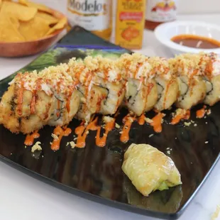 a sushi roll on a black plate