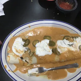 a plate of enchiladas with sauce
