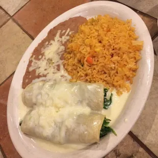 Vegetarian dish - spinach &amp; cheese enchiladas with rice and beans.