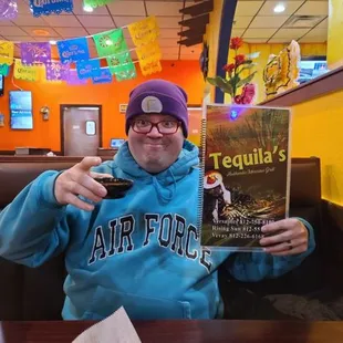 a man holding up a book