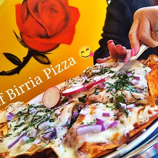  a person cutting a pizza