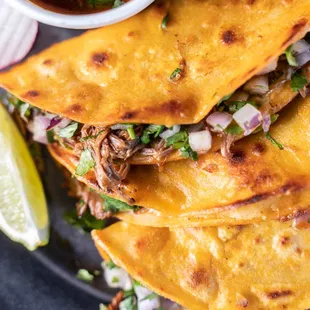 a plate of tacos with salsa