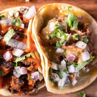 three tacos on a cutting board