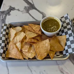 Chips and green salsa.
