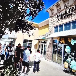 Line of people waiting patiently for their Grand Opening.