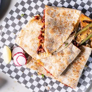 a quesadilla with a side of potato wedges