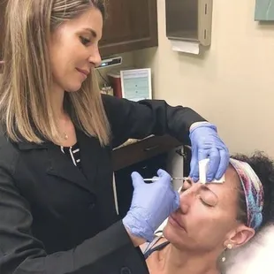 Dr. Laura injecting Xeomin (similar to Botox, which we also provide) into one of our beautiful patients