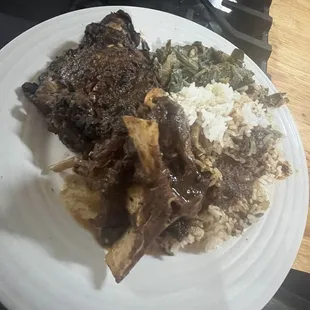 Jerk chicken, oxtail, rice and greens
