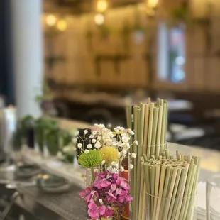 a vase of flowers and straws