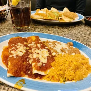 a plate of enchiladas and rice