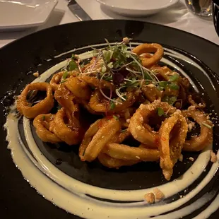 CRISPY FRIED CALAMARI TOSSED IN A SWEET AND SPICY THAI CHILIE SAUCE WITH CRUSHED HONEY PEANUTS