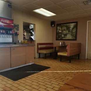 Small interior with 7 tables and a beverage station