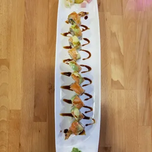 a plate of sushi on a wooden table