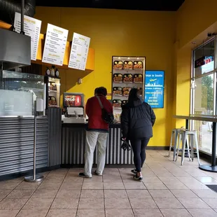 two people standing at a counter