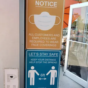 a sign stating customers to wear face coverings