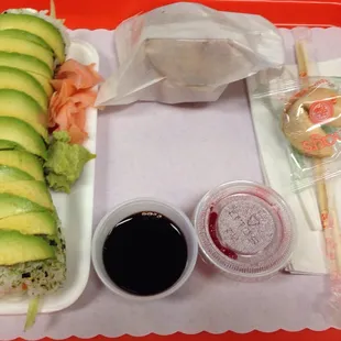 Philadelphia roll with avocado on top with a side of creme cheese wontons