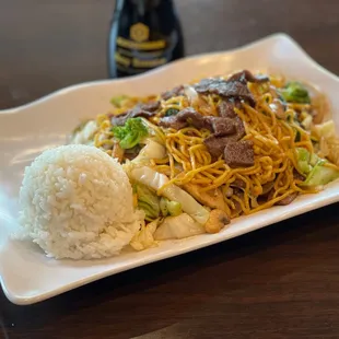 a plate of noodles and meat