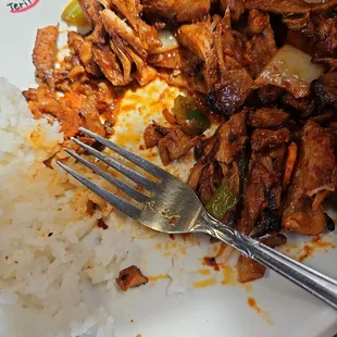 a plate of food with rice and meat