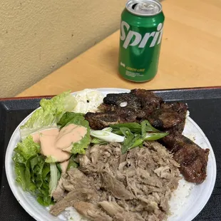 a plate of food and a can of soda