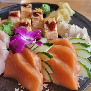 a plate of sushi and a bowl of salad