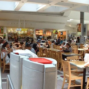 a large group of people eating in a restaurant