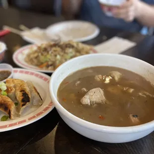 a bowl of soup and a plate of dumplings
