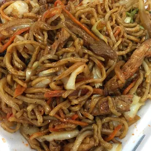 a plate of noodles and meat