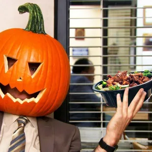 a man wearing a pumpkin head