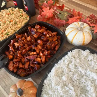 a table full of rice, meat, and vegetables