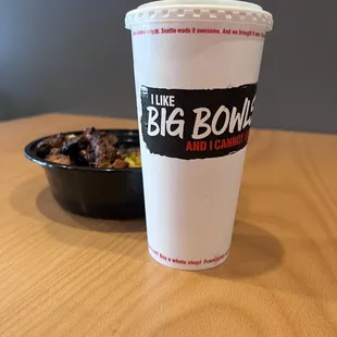 a big bowl of food and a drink