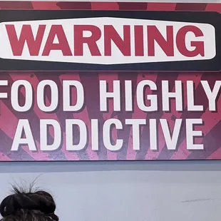 a sign warning food highly addictive