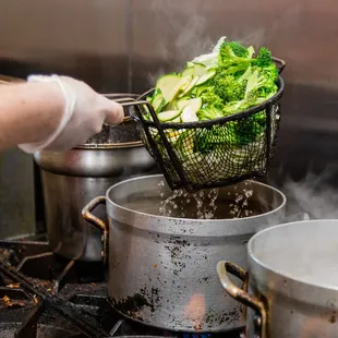 a person cooking broccoli