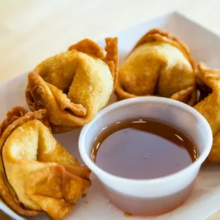 a bowl of sauce and some fried food