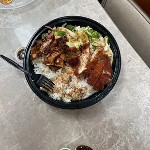a plate of rice, meat, and vegetables