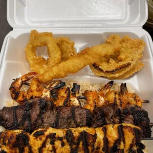 a chicken skewer and onion rings