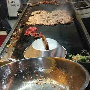 Yakisoba steaming and chicken teriyaki cooking.