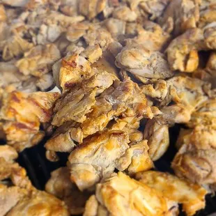 chicken being cooked on a grill