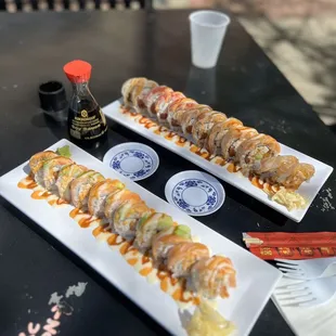 two plates of sushi with sauce