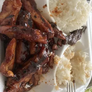 ribs and rice on a styrofoam plate