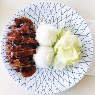 a plate of food with rice and lettuce