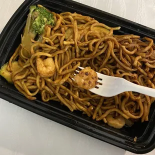 a fork and a plate of noodles